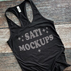 May include: Black racerback tank top with the text "SATI MOCKUPS" in a retro font with white stars.
