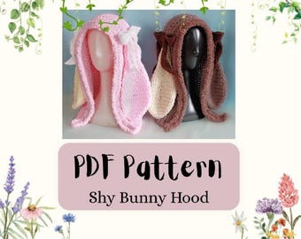 May include: Two crochet bunny hoods, one in light pink and one in dark brown, each featuring long ears and side bows. The text on the image reads PDF Pattern Shy Bunny Hood. The hoods are displayed on mannequin heads against a light background.