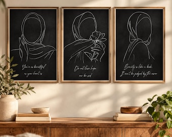 May include: A set of three vertical wall art prints featuring white line art illustrations of figures wearing hijabs on a black background. Each print includes white cursive text: You're as beautiful as your heart is, Do not lose hope nor be sad, and Beauty is like a book. It can't be judged by the cover.