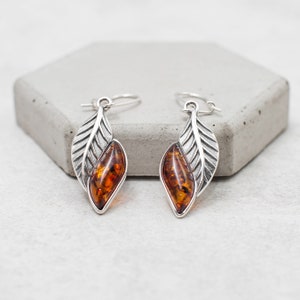 Experience the beauty of Baltic amber with our Amber Earrings. The stunning leaf design, solid sterling silver frame, and marquise amber cabochon create a one of a kind accessory that is sure to become a treasured part of your jewelry collection.