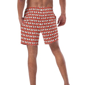 Può includere: Costumi da bagno rossi con motivo a farfalla bianca.