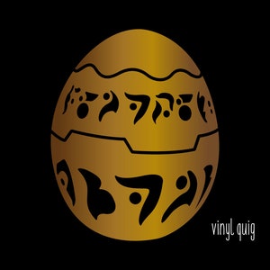 May include: A golden egg with black markings and a wavy line around the middle. The egg has a pattern of symbols on it.