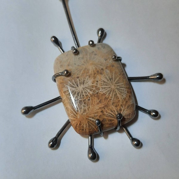 Sterling silver pendant with fossilized coral