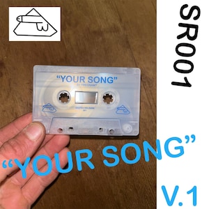 Könnte beinhalten: Eine transparente Kassette mit dem blauen Text "YOUR SONG". Auf dem Band steht auch "BY PREGNANT" und "SELFISH RELEASE 001". Das Bild enthält ein Logo und den Text "SR001 V.1".