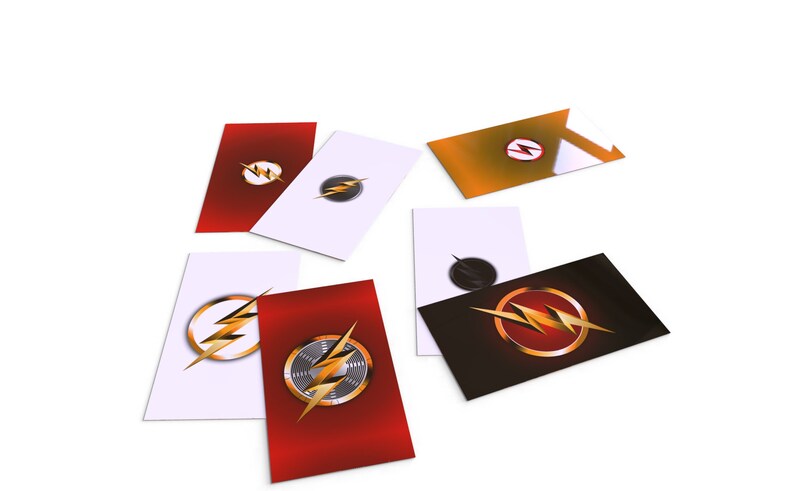 May include: Six different cards with the Flash logo on them. The logos are in different colors and styles, including red, white, black, and gold.
