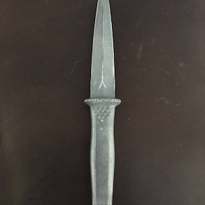 May include: A silver-colored dagger with a pointed blade and a textured handle.