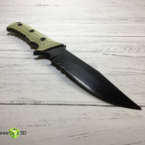 May include: A black and green tactical knife with a serrated blade and a textured handle.