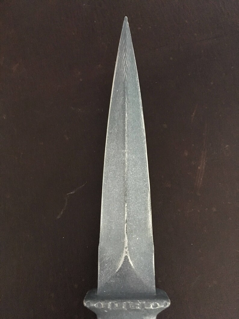 May include: A silver dagger with a sharp point and a textured blade.