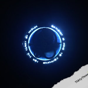 May include: A blue glowing ring with the text "FOR THE GLORY OF MERLIN TO COMMAND DAYLIGHT IS MINE" around the outside.