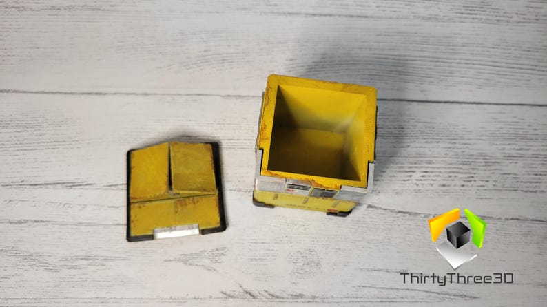 May include: A yellow and gray box with a lid. The box is open and the inside is empty. The box is made of wood and has a distressed look.