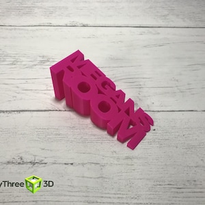 May include: A pink 3D printed word block that reads "MEGAN ROOM".