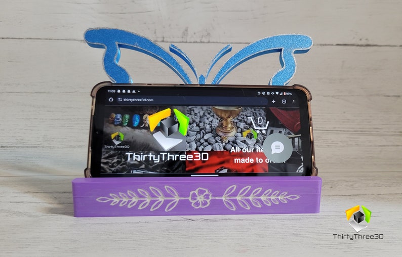 Peut inclure: Un support de t&eacute;l&eacute;phone violet avec un motif floral et un support de t&eacute;l&eacute;phone en forme de papillon bleu. Le support de t&eacute;l&eacute;phone est en bois et poss&egrave;de une fente pour un t&eacute;l&eacute;phone. Le support de t&eacute;l&eacute;phone est en plastique et a un design de papillon. Le support de t&eacute;l&eacute;phone est un excellent moyen de garder votre t&eacute;l&eacute;phone debout et facilement accessible.