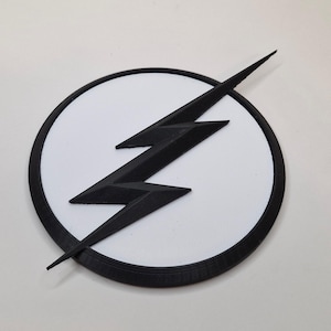 May include: A black lightning bolt emblem on a white circle, set against a white background. The emblem has a black border. The lightning bolt is a stylized, three-pronged design.