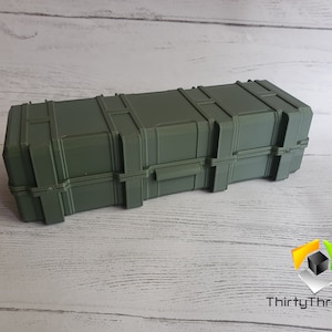 May include: A dark green rectangular storage case with a textured surface and multiple latches. The case is made of plastic and has a slightly worn appearance.
