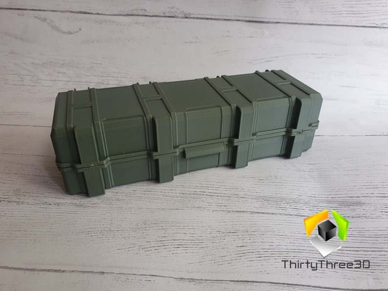 May include: A dark green rectangular storage case with a textured surface and multiple latches. The case is made of plastic and has a slightly worn appearance.
