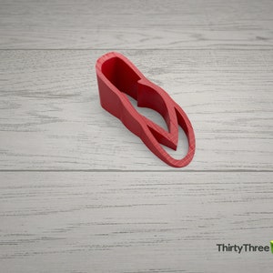 May include: A red plastic doorstop shaped like a flip-flop.