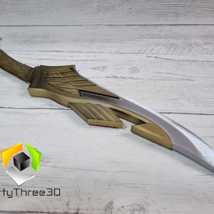 May include: A gold and silver decorative sword with a wing design. The sword is made of plastic and is approximately 20 inches long.