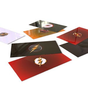 May include: A set of six cards featuring the Flash logo in different colors. The cards are black, white, red, orange, and two shades of gray. Each card has a glossy finish.