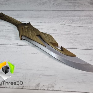 May include: A silver and gold-colored fantasy-style dagger with a curved blade and intricate details. The dagger is made of a durable material and has a sharp point.