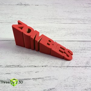 May include: Red wooden doorstop shaped like the word "ZOMBIES".
