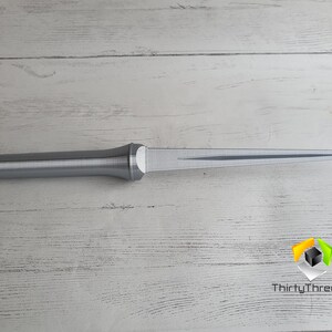 May include: A silver-colored, 3D printed dagger with a pointed tip and a textured handle.
