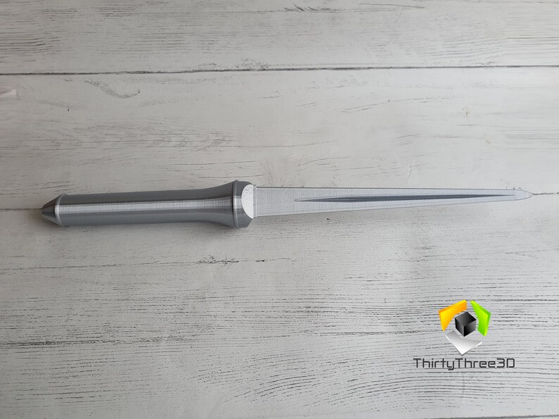 May include: A silver-colored, 3D printed dagger with a pointed tip and a textured handle.