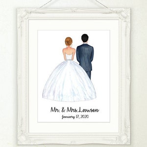 May include: A framed watercolor print of a bride and groom from the back, in a white frame. The bride wears a white wedding dress, and the groom wears a dark suit. The print includes the text "Mr. & Mrs. Lawson" and the date "January 17, 2020."