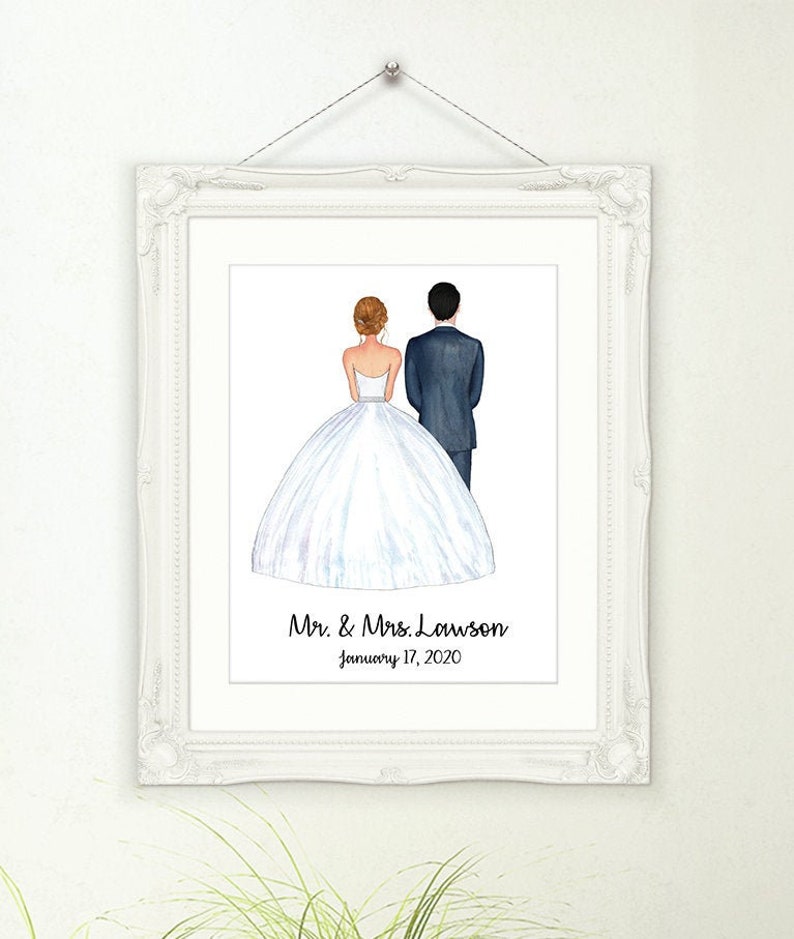 May include: A framed watercolor print of a bride and groom from the back, in a white frame. The bride wears a white wedding dress, and the groom wears a dark suit. The print includes the text "Mr. & Mrs. Lawson" and the date "January 17, 2020."