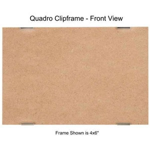 May include: A brown wood picture frame with silver clips. The frame is 4 inches by 6 inches.