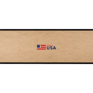 May include: A rectangular black picture frame with a light brown interior. The words "MADE IN USA" are printed in blue with a small American flag graphic. The frame is designed to hold a long, narrow image or artwork.