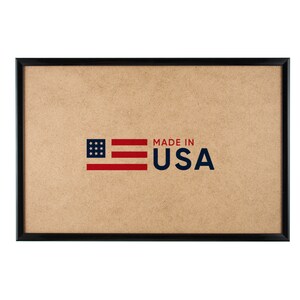 May include: A black picture frame with a brown corkboard backing. The corkboard has a red, white, and blue American flag graphic with the text "MADE IN USA" printed below it.