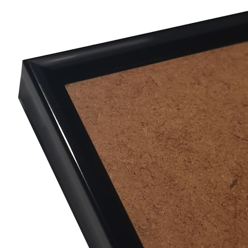 May include: A black picture frame with a brown mat.