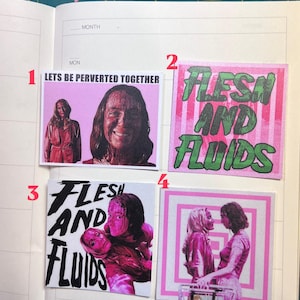 May include: Four square stickers featuring horror-themed imagery. Sticker 1 shows a person covered in blood with the text LETS BE PERVERTED TOGETHER. Sticker 2 has green text reading FLESH AND FLUIDS on a pink striped background. Sticker 3 features black text FLESH AND FLUIDS over a pink-toned image of two people. Sticker 4 depicts two people facing each other against a pink and white square pattern.