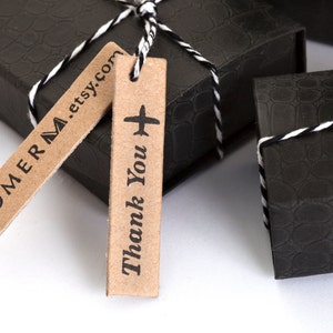 May include: Two black gift boxes with white string and brown gift tags. One tag says "TOMERM.etsy.com" and the other says "Thank You" with a small airplane icon.