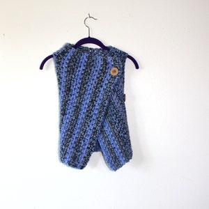 May include: A blue and gray striped crocheted infinity scarf with a wooden button.