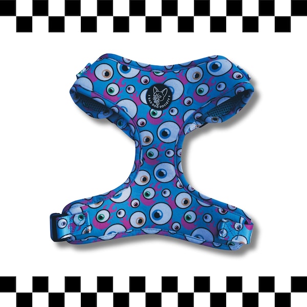 May include: A blue pet harness featuring a repeating pattern of various eyeballs in shades of white, blue, and green, interspersed with pink flame-like shapes. A circular black patch with a white dog illustration and the text BAD DOG SOCIETY.