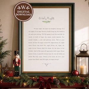 May include: A framed wall art print featuring the lyrics to O Holy Night in black text on a white background, displayed in a dark green frame with gold trim. The print includes a small green sprig graphic and the number 25 at the bottom.