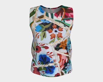 May include: A sleeveless tank top with a colorful mosaic pattern featuring blue, red, green, and white floral designs.