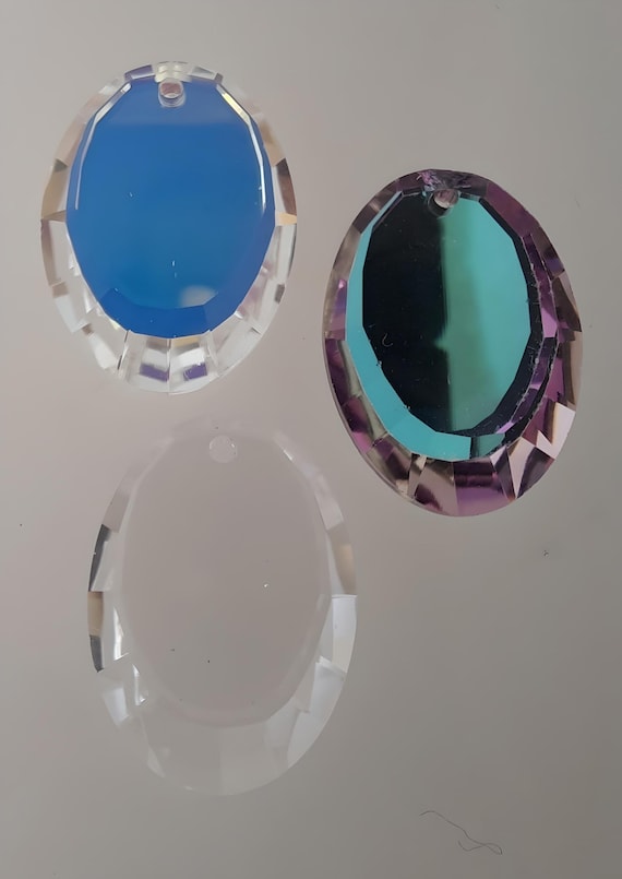 Swarovski® 6120 18mm Oval Disc Pendant. Available in 3 colors, Crystal Clear, Crystal AB, & Vitrail Light. Genuine Swarovski ELEMENTS