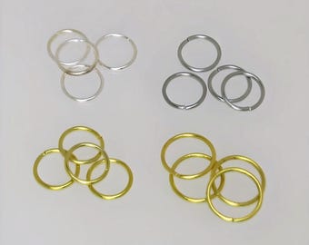 May include: Three sets of jump rings in silver, gold, and black metal. Each set contains three jump rings.