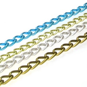 May include: Four different chain styles in blue, gold, silver, and green. The chains are all the same length and are laid out in a diagonal line.