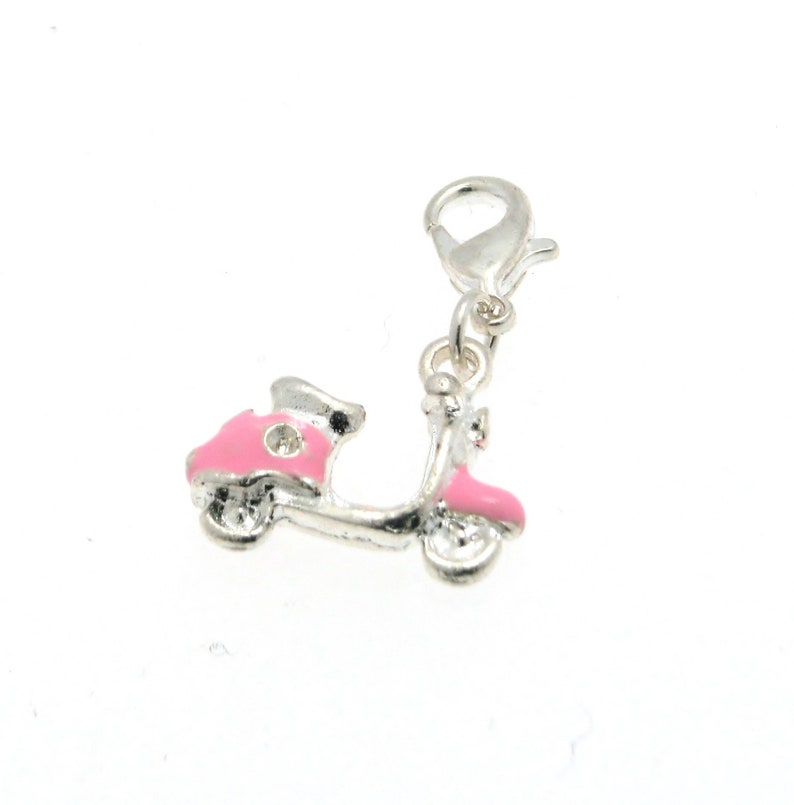 May include: A silver charm in the shape of a pink scooter with a silver clasp.