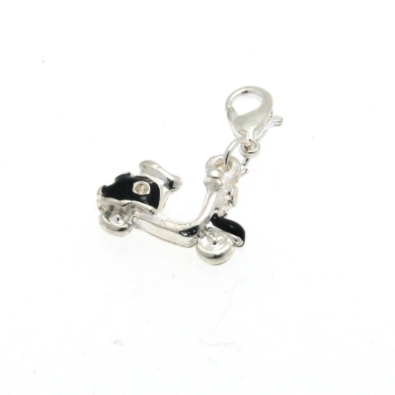 May include: Silver charm in the shape of a black scooter with a silver clasp.