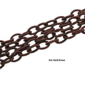 May include: A close-up of a dark brown elastic chain. The chain is made of a series of connected oval links. The chain is a popular choice for crafting and jewelry making.