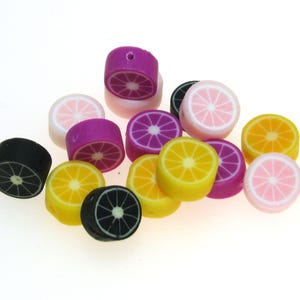 May include: Assortment of colorful fruit slice shaped beads. The beads are made of polymer clay and feature a variety of citrus fruits, including lemons, limes, and oranges. The beads are perfect for jewelry making, crafting, and other DIY projects.