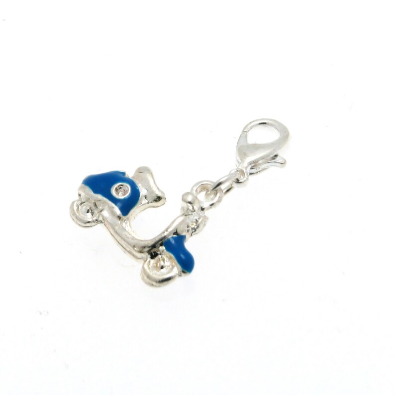 May include: Silver charm with a blue enamel scooter design. The charm has a lobster clasp for attaching to a bracelet or necklace.