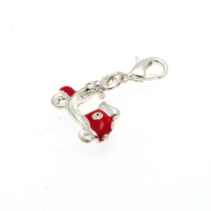 May include: A silver charm in the shape of a red scooter with a silver clasp.