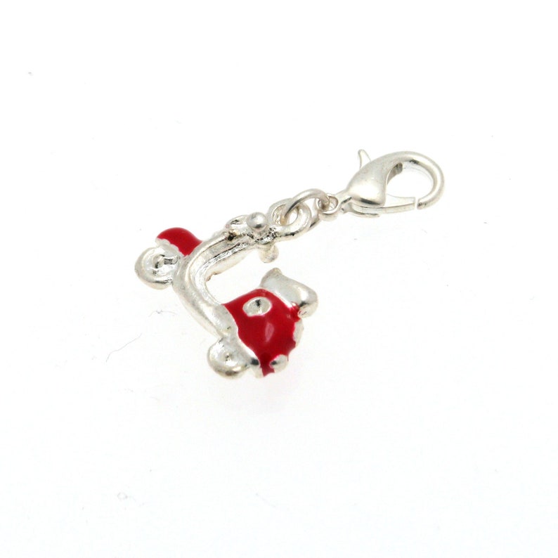 May include: A silver charm in the shape of a red scooter with a silver clasp.