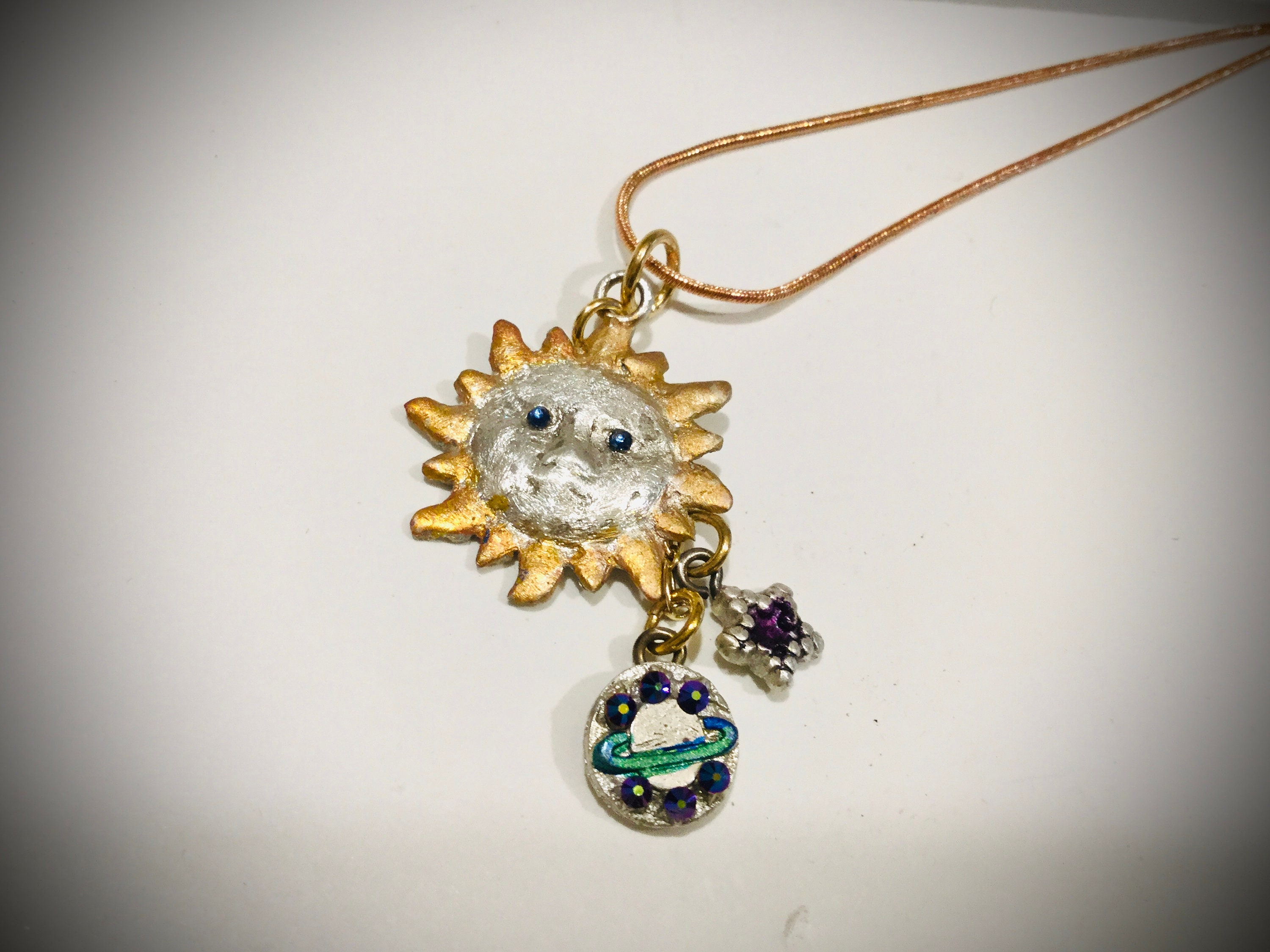 B1024 Pure silver .999 sun pendant w/sapphire eyes, dangling planet & star also pure sliver, all handmade, one of a kind, jewelers dye color