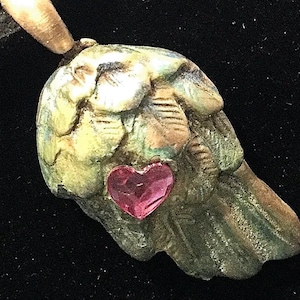 CF007. Bronze angel wing with cubic zirconia heart shaped garnet